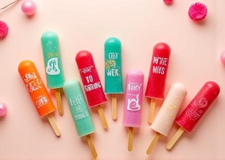 A display of custom-branded ice lollies, some with company logos and personalized messages, for special events.